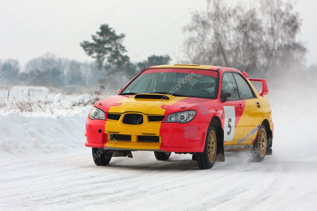 Red and yellow rally car on snow