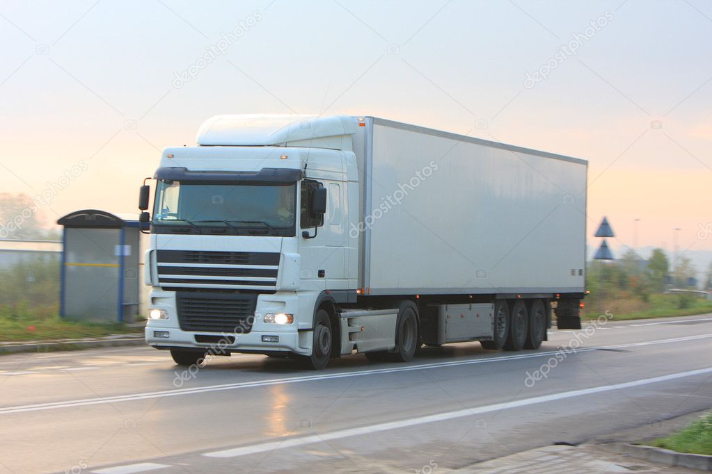 Truck with tank in motion on morning road