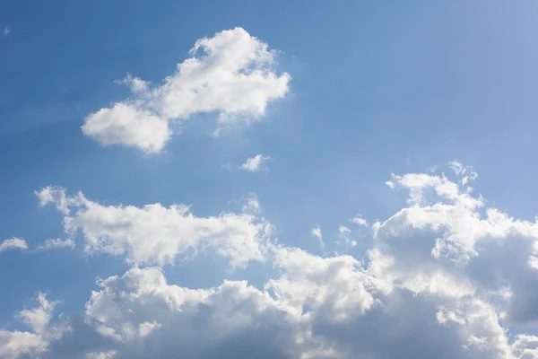 Bright white and dark stormy cumulus clouds with a blue sky in t ...