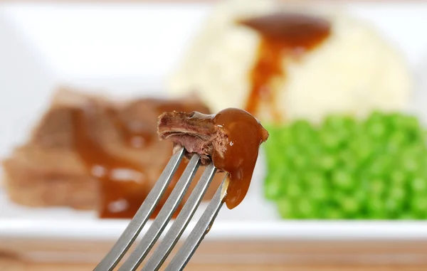 Roast beef and gravy on a fork — Stock Photo, Image