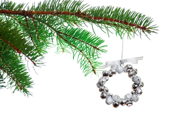Silver Christmas bell wreath on a branch — Stock Photo, Image