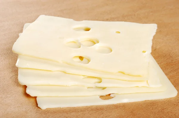 Swiss cheese on wood cutting board — Stock Photo, Image