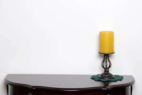 Table with a wax candle lamp — Stock Photo, Image