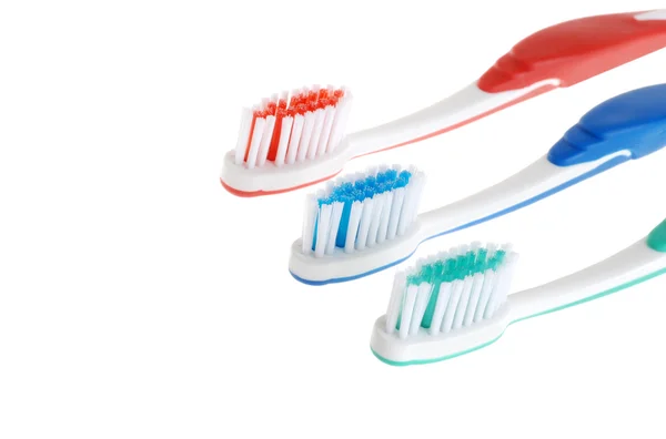 Three toothbrushes focus on blue one — Stock Photo, Image