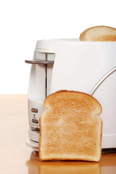 Toast leaning on toaster — Stock Photo, Image
