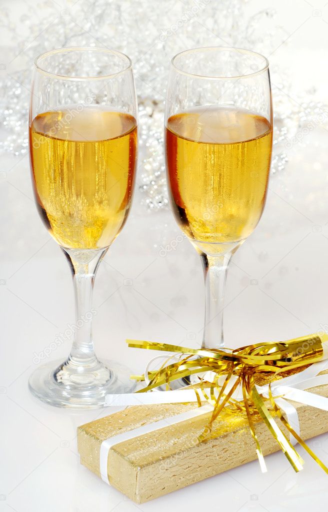 Two glasses of champagne with present and horn