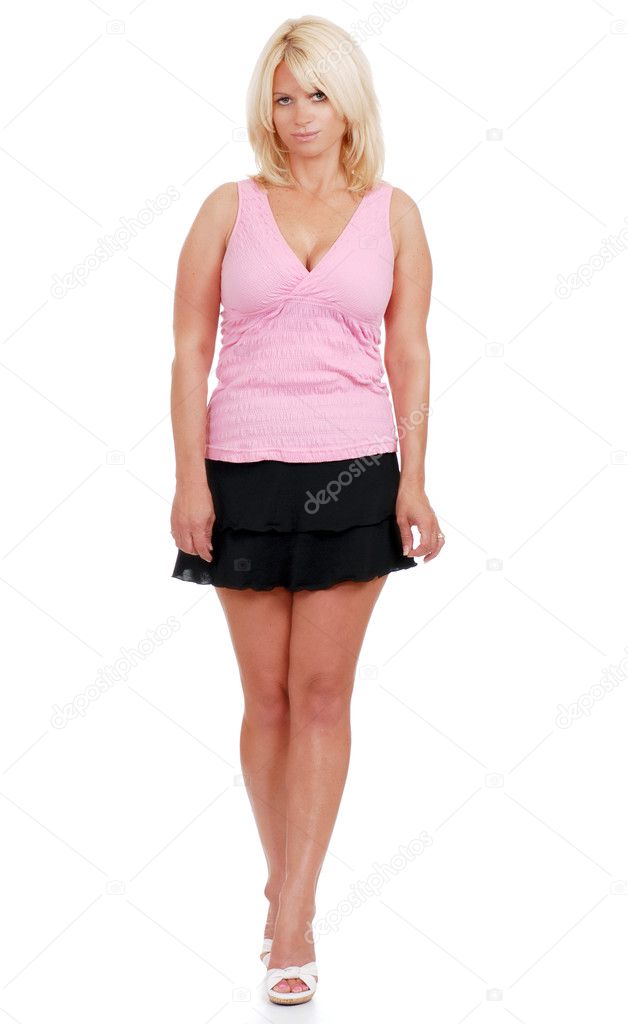 Isolated mature woman wearing short skirt and pink top on white background