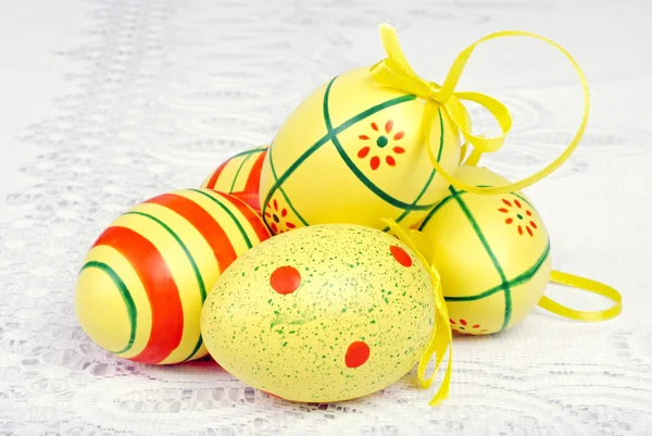 Easter eggs on white lace — Stock Photo, Image