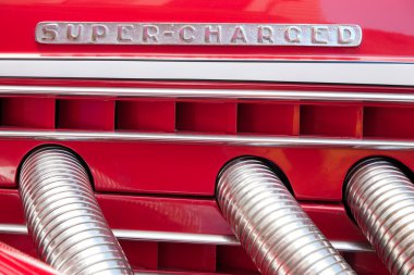 Closeup of the Super-charged sign on a classic Duesenberg at the Auburn, Cord, Duesenberg Festival in Auburn, Indiana clipart