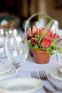 Formal table arrangement with a floral centerpiece clipart