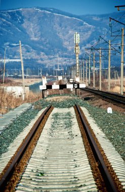 Railway deadlock in the winter against mountains clipart