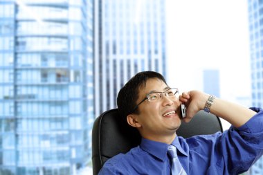 Asian businessman on the phone clipart