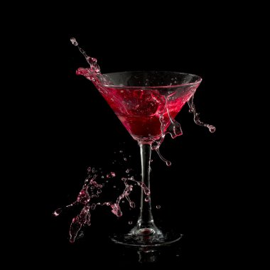 Red martini cocktail splashing