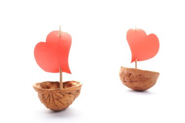 Sailboats made of walnuts with a heart sail isolated on white background clipart