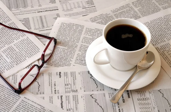 Coffee over newspaper — Stock Photo, Image