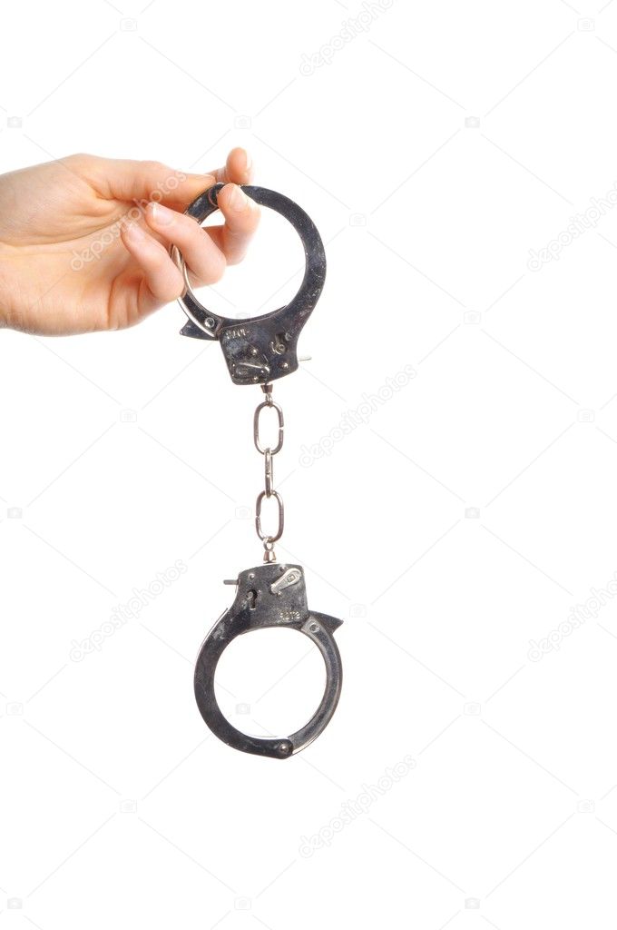 Hand wearing handcuffs isolated on white background