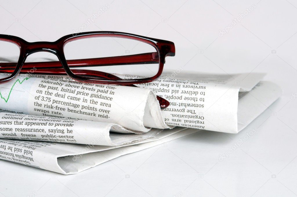 Stack of old newspapers isolated on white