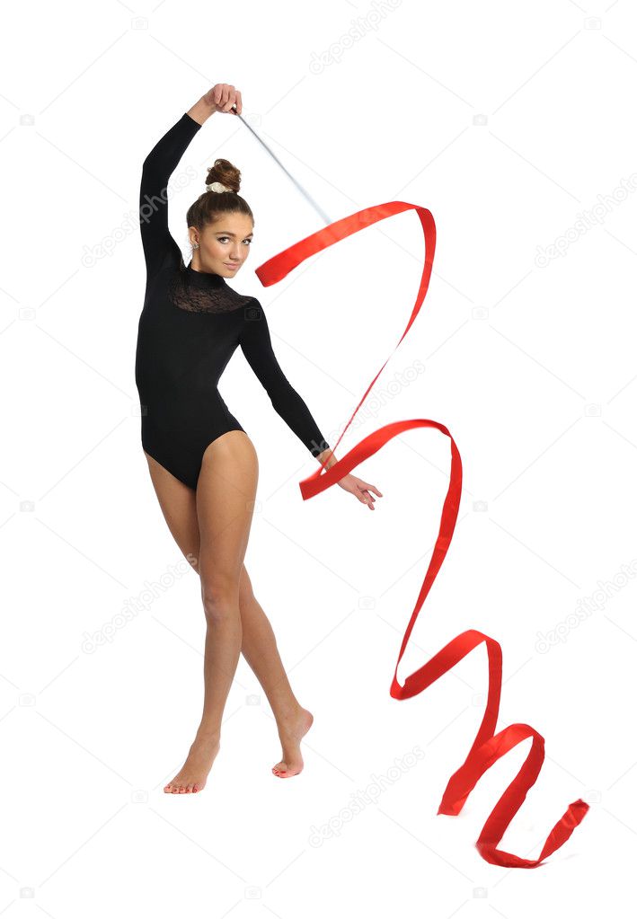 Girl gymnast in black sport suit with red ribbon isolated on white background