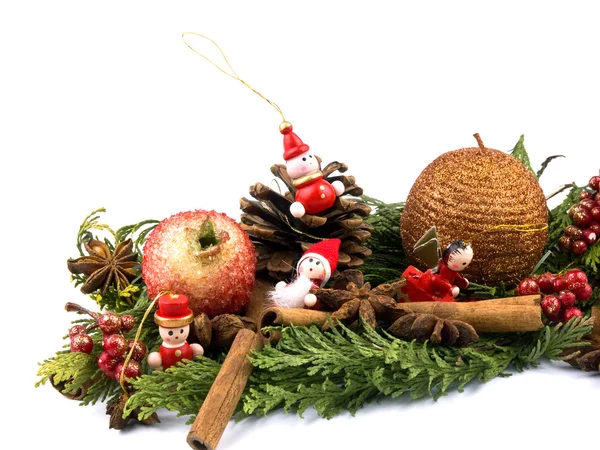 stock image Christmas arrangement with thuja branches, sparkling candle and small wooden figure on white background