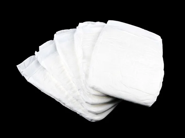 Stock of white diapers on black — Stock Photo, Image