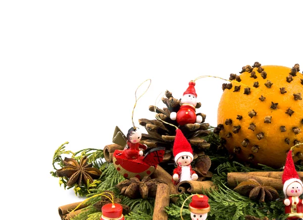 stock image Closeup picture of thuja branches, orange, spices and small wooden figure on white background. Available space for text.