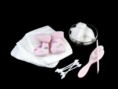 Newborn baby accessories on black background clipart