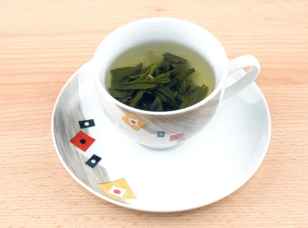 Kopp grönt te på träbord — Stockfoto