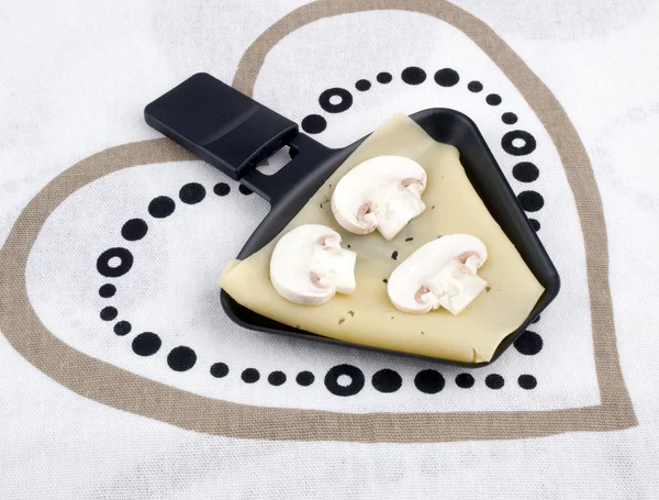 Raclette pan with cheese and mushroom - party food — Stock Photo, Image