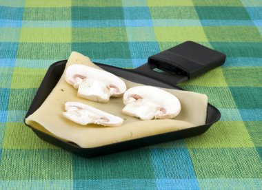 Raclette pan with cheese and mushroom clipart