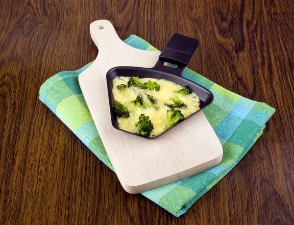 Broccoli with raclette cheese — Stock Photo, Image
