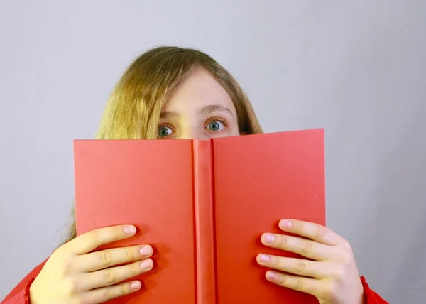 stock image Young girl looking over book