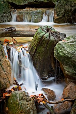 Small waterfall in autumn river clipart