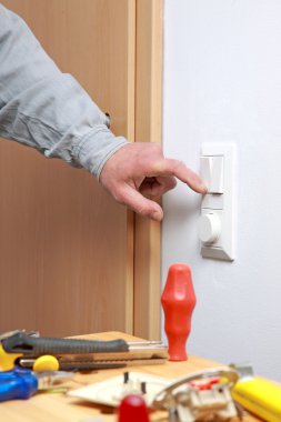 Installing a light switch. clipart