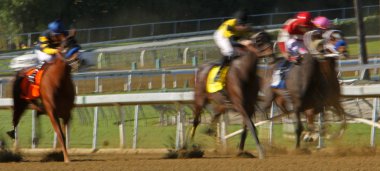 Motion blur of racing jockeys and horses clipart