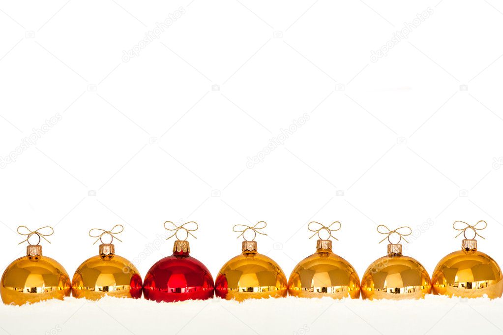 Golden christmas baubles in the snow