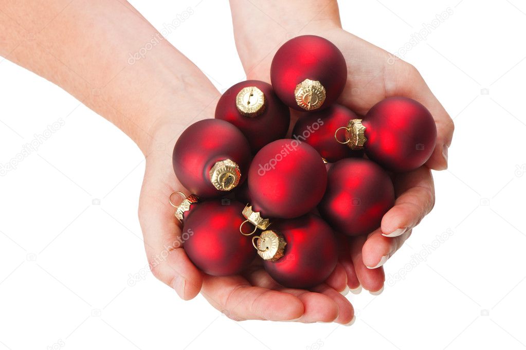 Red christmas baubles in hands