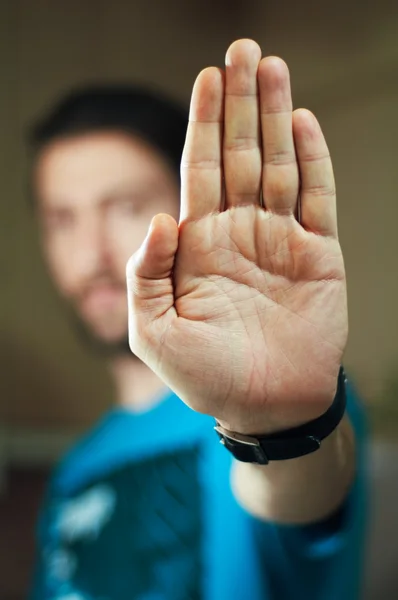 Jovem gesticulando pare com a mão — Fotografia de Stock