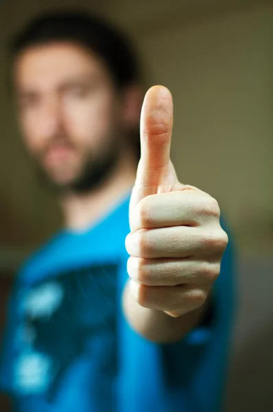 stock image A young man showing sign okay