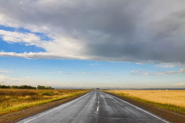 stock image Summer landscape with rural road and cloudy sky