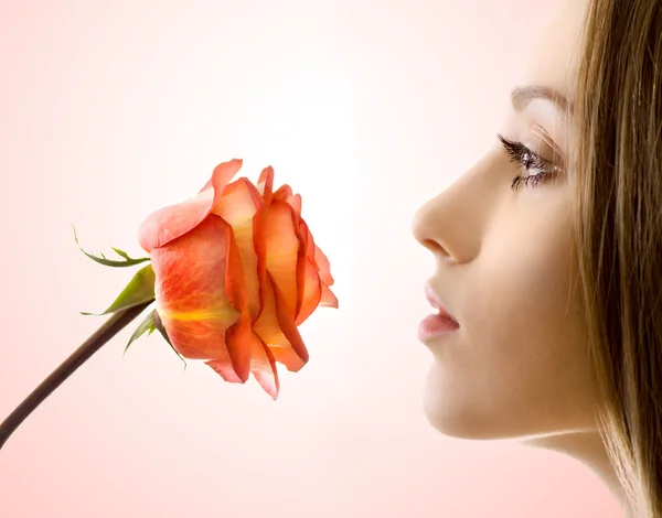 Beautiful woman with rose sideview isolated — Stock Photo, Image