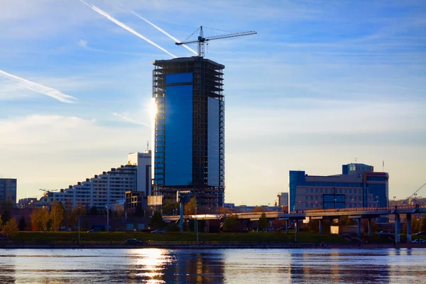 stock image Industrial construction crane near the skyscraper in Krasnoyarsk