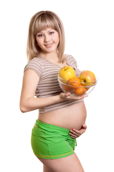 배경에 접시에 과일과 임신한 여자의 초상화 — 스톡 사진