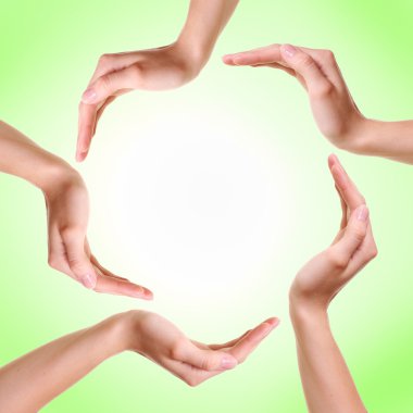 Woman's hands made circle on green background clipart