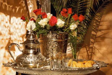 Moroccan tea set with pasteries clipart