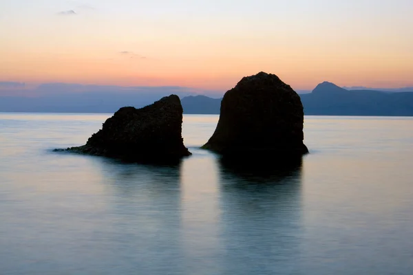 Mörka stenar i havet bevattnar — Stockfoto