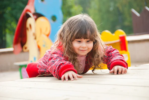 Little girl plays in playground — Stock Photo, Image