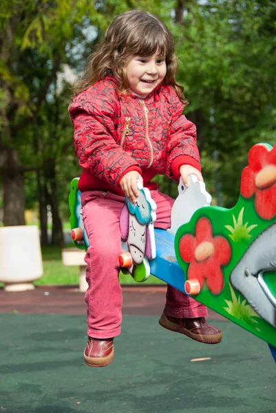 Little girl plays in playground — Stock Photo, Image