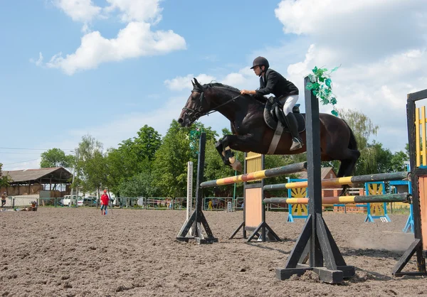 Jockey hoppar över ett hinder — Stockfoto