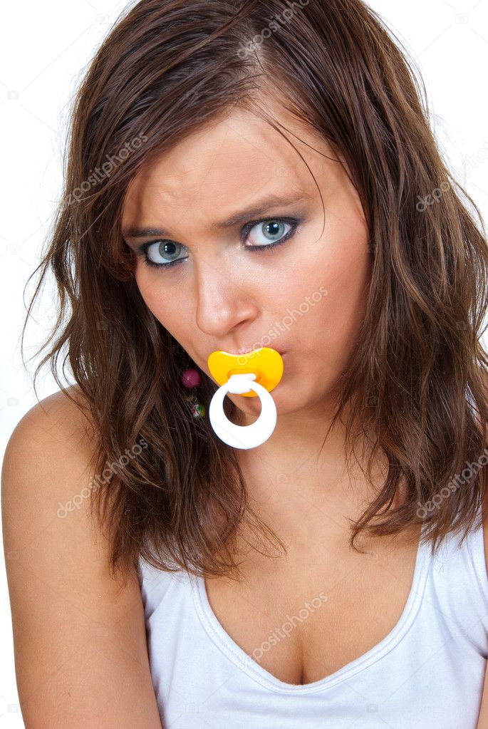 Frightened girl sucking a pacifier