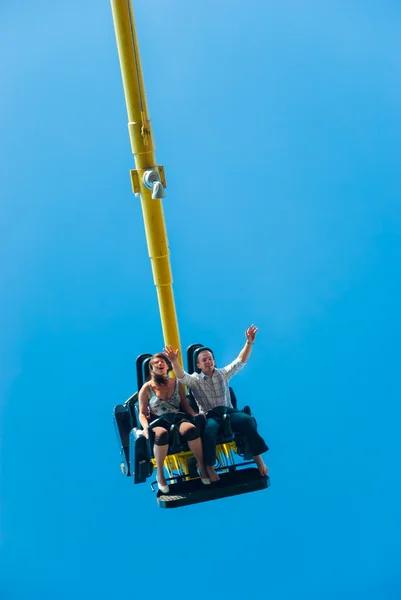 Couple riding on the attraction — Stock Photo, Image